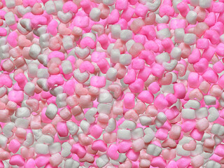 白とピンク色のハート形の発泡スチロール製緩衝材の背景素材