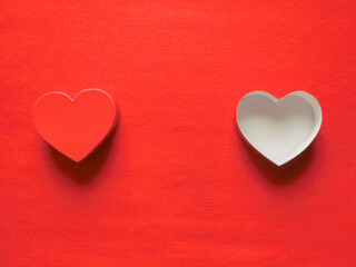 赤いフェルトの左右に置いた赤いハート形の蓋と白い箱