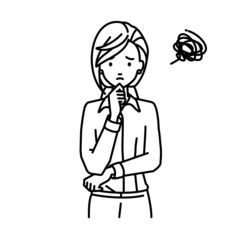 立って手をあごにあてて困っているブラウスの女性