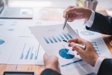 Business people meeting at office Executives and accountants meeting about the company's revenue graph in the office with laptops planning strategy and brainstorming, colleagues thinking concept