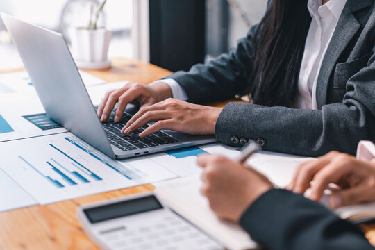 Business people meeting at office Executives and accountants meeting about the company's revenue graph in the office with laptops planning strategy and brainstorming, colleagues thinking concept