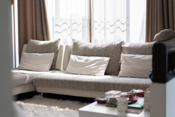 White clean sofa and pillows at living room in the morning time