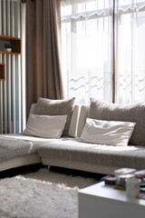 White clean sofa and pillows at living room in the morning time