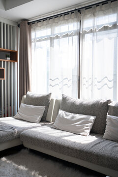 White clean sofa and pillows at living room in the morning time