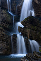 Naklejka premium Beautiful waterfall cascading down cliff and boulders in Australian high country