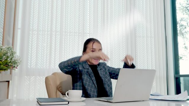 Happy business woman excited surprised work at white office desk with pc laptop throwing up paper account documents, woman boss throw papers fly in air she success work project