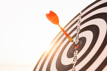 Closeup the dart arrow hit center on Bullseye(bull's-eye) of a dartboard is a target of challenge...