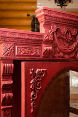 Closeup opened door of old renovated cupboard with amazing hand carved ornaments with wooden house...