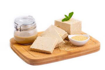 From traditional Turkish desserts; Presentation on a white background with tahini halva, sesame halva, tahini and sesame.