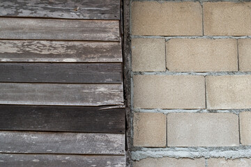 Brick wall and wooden wall divided in half for background
