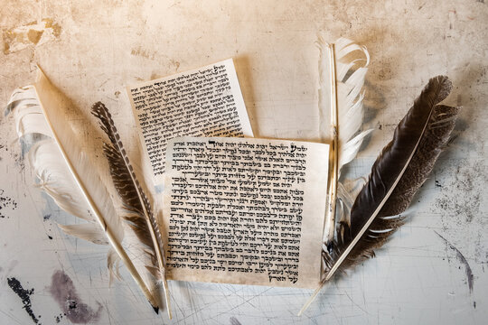 Mezuzah parchment made from animal skin with the full text of the Shema Yisrael prayer in Hebrew and the feather quills used to write the Hebrew text taken from the Bible.
