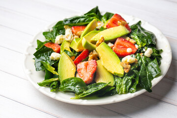 Healthy diet salad; Strawberry Spinach Salad with Avocado.