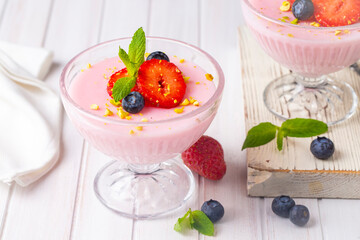 Strawberry Cream Dessert with some blueberries on a wooden board