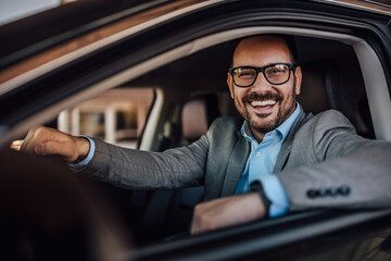 Close up of a happy man ready to drive his new car for the first - Powered by Adobe