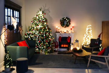 Blurred view of decorated room with Christmas tree and fireplace