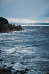 Naklejka premium dark clouds on a windy beach shore coast