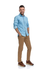 Fototapeta premium happy man in his forties holding hands in pockets and smiling