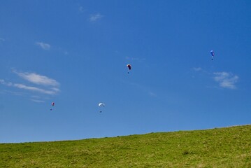 Paragliders in the sky at Niedere in Bregenzerwald. Vorarlberg, Austria.