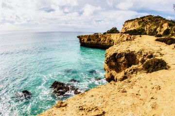 cliffs and turquoise ocean Albufeira portugal