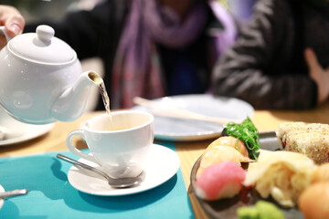 Person pouring green tea