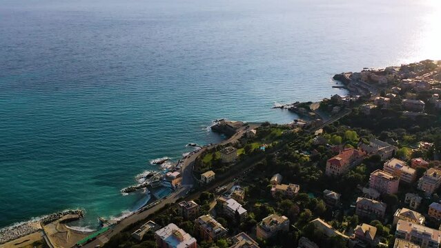 Aerial view overlooking villas at the shore of Quarto dei Mille, sunny Genova, Italy - tilt, drone shot