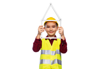 building, construction and profession concept - little boy in protective helmet and safety vest with ruler in shape of house over white background