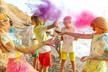 Children play in nature. Holi colors. High quality photo