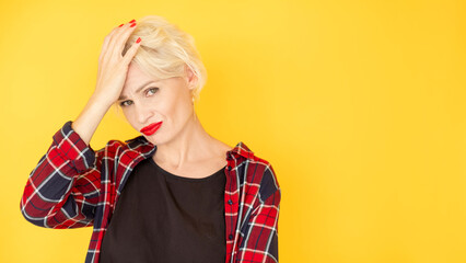 Facepalm gesture. Confused woman. Clueless situation. Embarrassed beautiful lady covering face with hand feeling epic fail isolated yellow copy space.