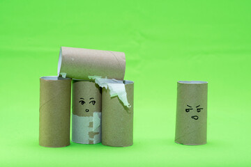 Stylized girl and an evil man made of toilet paper rolls.
