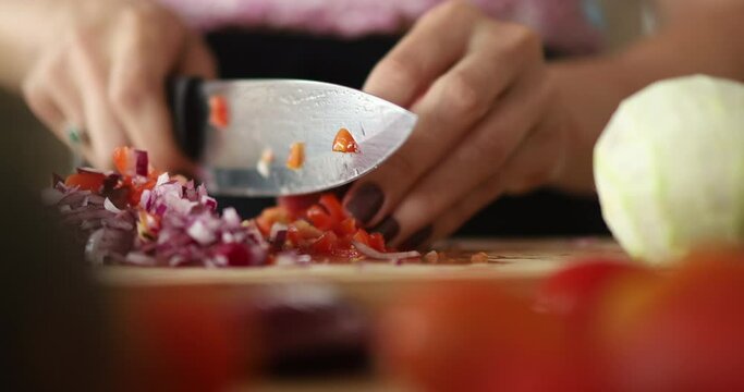 Happy and healthy young woman meal prepping whole vegetarian meal in the kitchen. High quality video. Feel good, healthy and health concept.