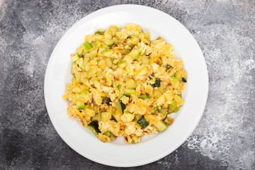 scrambled egg with zucchini on white small plate