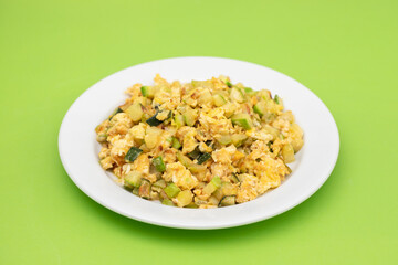 scrambled egg with zucchini on white small plate