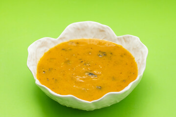 vegetable soup with spinach in beautiful bowl and spoon