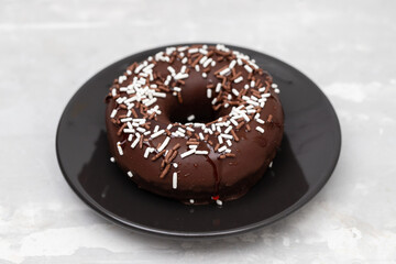 chocolate doughnut on small dish on ceramic