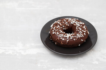 chocolate doughnut on small dish on ceramic