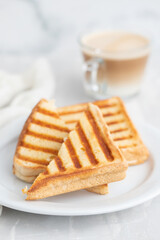 fresh breakfast toasts on white plate on ceramic