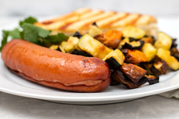 fried sausage with vegetables and toast on plate
