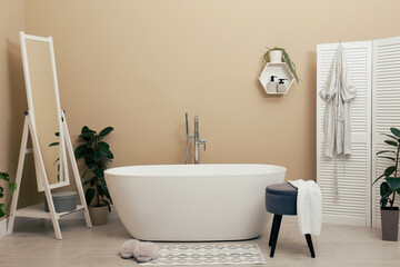 Fototapeta na wymiar Cozy bathroom interior with stylish ceramic tub