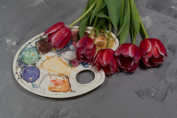 Flowers pink tulips on a gray background with paints