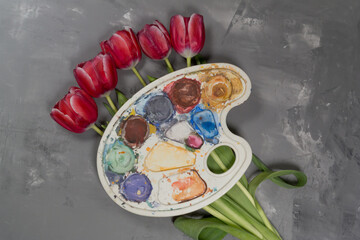 Flowers pink tulips on a gray background with paints