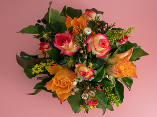 Basket of flowers on a pink background. Beautiful bouquet of flowers.