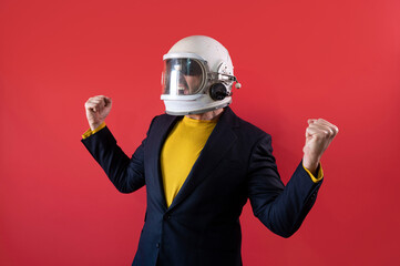 Businessman with astronaut helmet celebrating elated fists