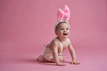 Obraz na płótnie Canvas Portrait of crawling little baby wearing bunny costume