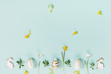 Festive Easter border, frame from easter eggs and spring flower crocus on blue background. Stylish...