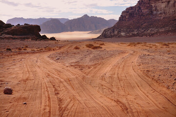 Fototapeta na wymiar empty winding roads in the Wadi Rum desert, red relief mountains around, nature of Jordan 