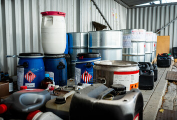 Metal and plastic barrels containing hazardous chemicals from industry, waste management concept,...