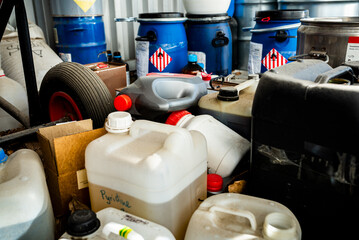 Metal and plastic barrels containing hazardous chemicals from industry, waste management concept,...