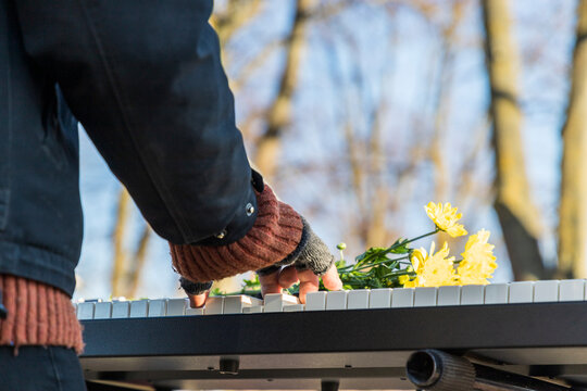 Man plays electric piano with hand