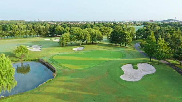 Aerial footage of green golf course in summer season