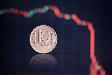 Close-up of the ruble on the background of the falling graphics, the concept of inflation, the...